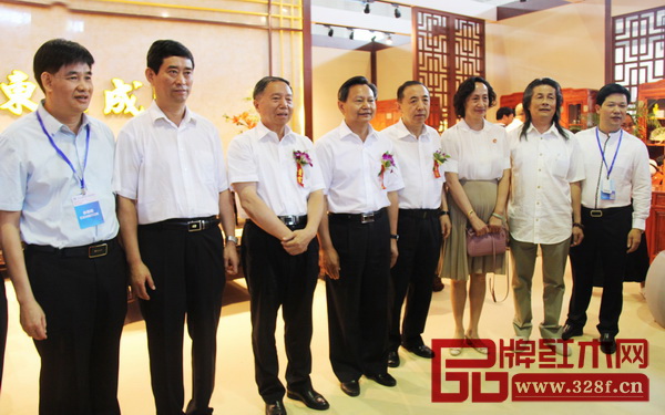  中國(guó)輕工聯(lián)合會(huì)會(huì)長(zhǎng)張崇和（左四），中國(guó)輕工業(yè)聯(lián)合會(huì)黨委書記步正發(fā)（左三），全國(guó)政協(xié)委員楊志明（右四），中國(guó)家具協(xié)會(huì)理事長(zhǎng)朱長(zhǎng)嶺（左二）、秘書長(zhǎng)張冰冰（右三），大涌鎮(zhèn)黨委委員謝巧明（左一），伍氏興隆董事長(zhǎng)伍炳亮（右二）等領(lǐng)導(dǎo)嘉賓蒞臨東成紅木展館參觀指導(dǎo)，并與東成紅木董事長(zhǎng)張錫復(fù)（右一）合影留念