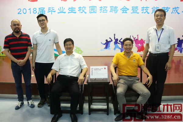 廣州市人社局副局長何士林（左三），廣州市輕工技師學(xué)院校長葉軍峰（右一），集古韻今董事長陳新平（右二）、工藝總監(jiān)陳正民（左一），與世界技能大賽精細(xì)木工項目選手翟梓曦共同合影