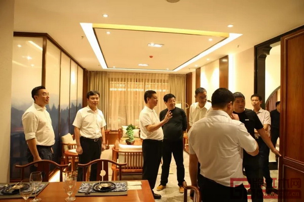 中國傳統(tǒng)工藝大師、國壽紅木董事長陳國壽(左三)為嘉賓詮釋世外桃源樣板房的構(gòu)思理念 中國傳統(tǒng)工藝大師、國壽紅木董事長陳國壽(左三)為嘉賓詮釋世外桃源樣板房的構(gòu)思理念