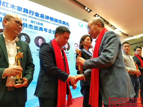 中國紅木家具技術專家曹新民為大匯堂董事長胡春龍頒發杰出青年企業家獎杯 中國紅木家具技術專家曹新民為大匯堂董事長胡春龍頒發杰出青年企業家獎杯