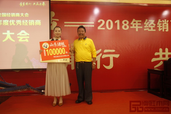  在明清居2017優秀經銷商表彰大會上，董事長金彪云（右）為獲獎經銷商頒獎