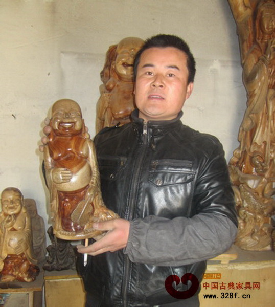 劉紅光向大家展示自己雕刻的彌勒佛