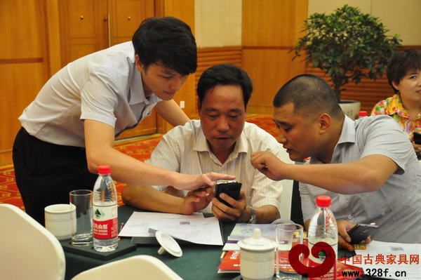 中國古典家具網工作人員正在指導與會人員進入游戲界面