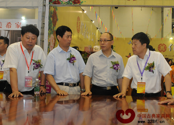 中國家具協會理事長朱長嶺、副理事長陳寶光等嘉賓駐足觀看紅木家具