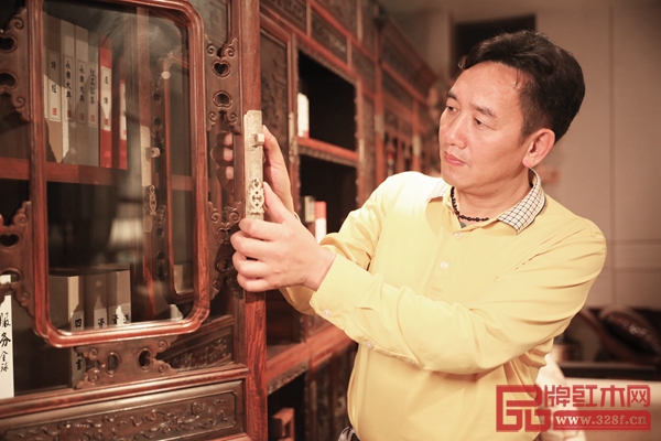 陳新平用心觸摸國方紅木家具,眼神里流露出對家具的喜愛與認同 陳新平用心觸摸國方紅木家具,眼神里流露出對家具的喜愛與認同